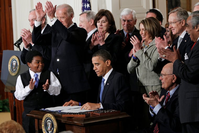 President Barack Obama is applauded after signing the Affordable Care Act into law in the East Room of the White House in Washington in March 2010.
