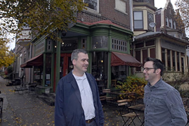Daniel Thut (leftO and Douglas Witmer outside the Greenline Cafe coffeehouse across from Clark Park.