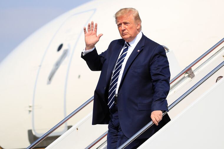 President Donald Trump waves as he walks from Air Force One upon arrival at Morristown Municipal Airport, in Morristown, N.J., Friday, July 19, 2019. (AP Photo/Manuel Balce Ceneta)