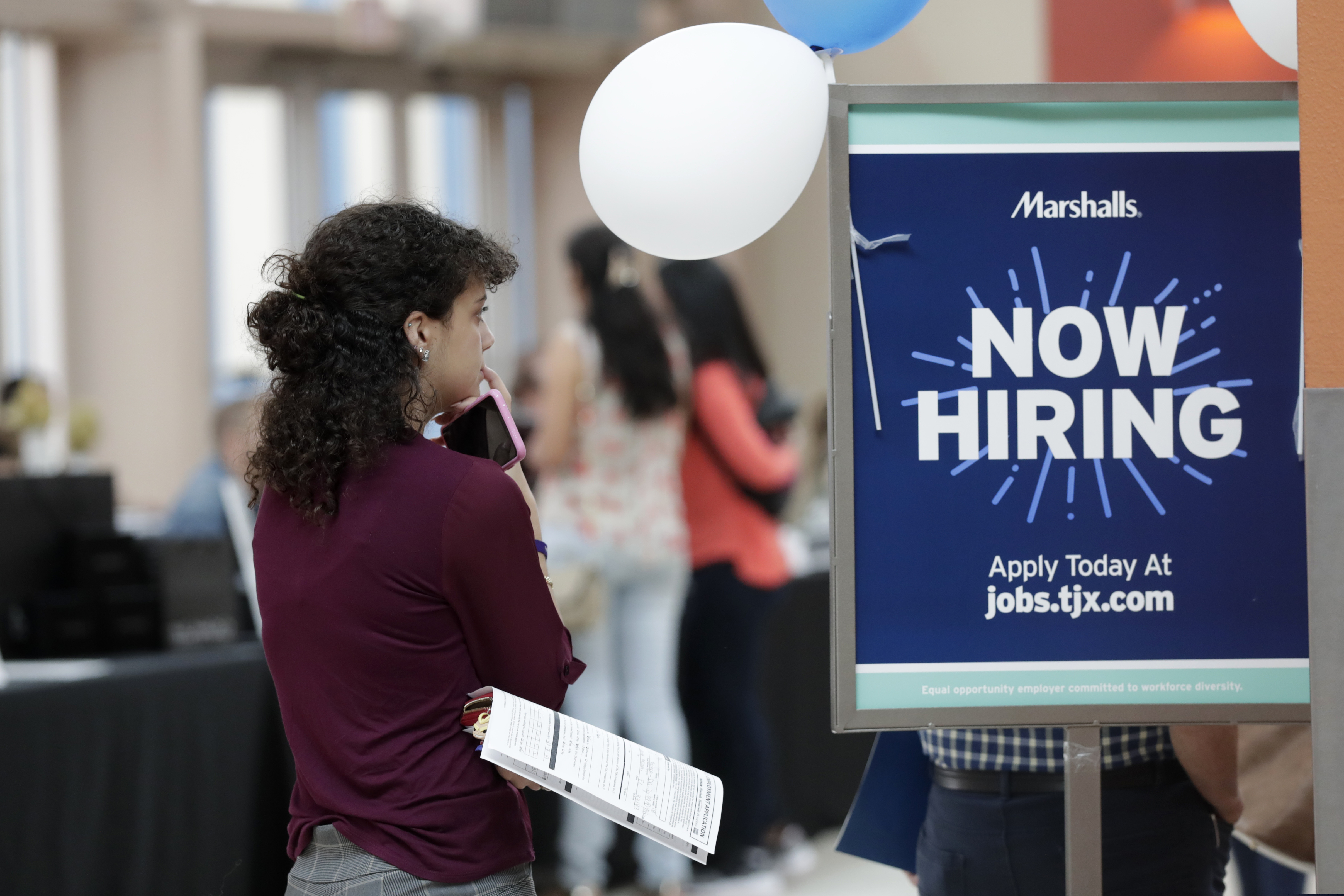 In this October 2019 Daisy Ronco waits in line to apply for a job with Marshalls during a job fair at Dolphin Mall in Miami. Businesses, nonprofits and government agencies posted nearly 7 million open jobs in January 2020, up 6.3% from the previous month.