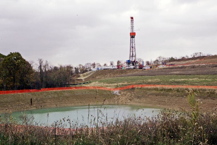 A drilling rig used to extract natural gas from the Marcellus Shale, located on a hill above a pond on John Dunn's farm in the Washington County borough of Houston, Pa., in 2008.