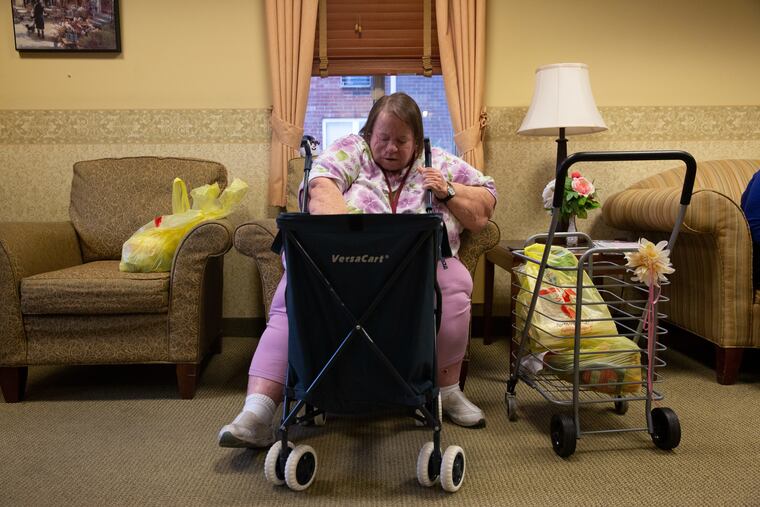 Ginny Kahr, who lives in Schwenckfeld Manor in Lansdale, checks her order of groceries from the food pantry at nearby Manna on Main Street.