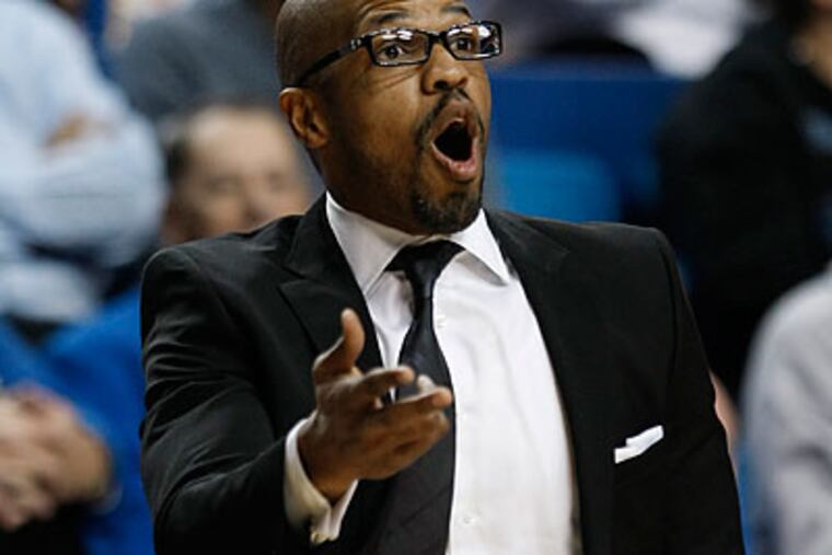 Penn coach Jerome Allen makes a point to his team during the first half. (Ed Reinke/AP)