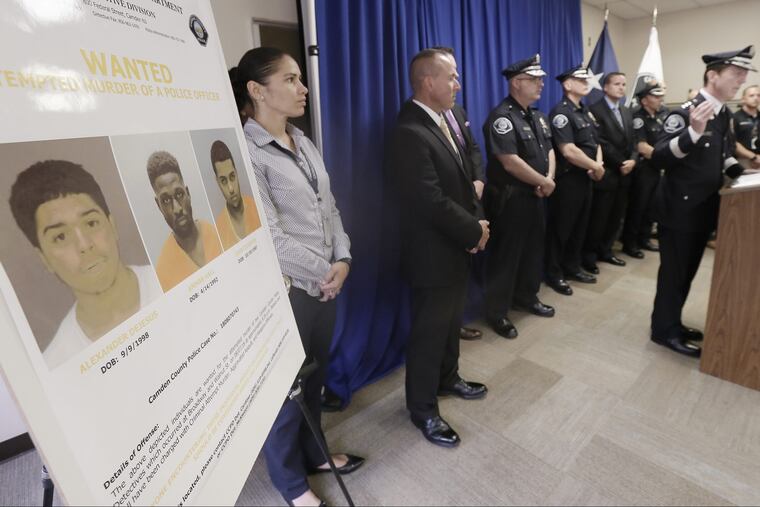 Law enforcement officials and Camden County Police Chief Scott Thomson (right) release photos of the 3 men wanted in connection with the attempted murder of two Camden County undercover detectives on Aug. 7,2018. ELIZABETH ROBERTSON / Staff Photographer