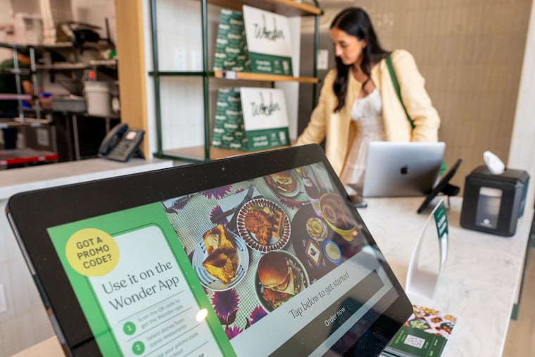 Jessica Malone, senior manager of brand marketing, prepares the order/pickup desk at Wonder Food Hall in the Garden State Park shopping center on Route 70 in Cherry Hill on May 27, 2025.