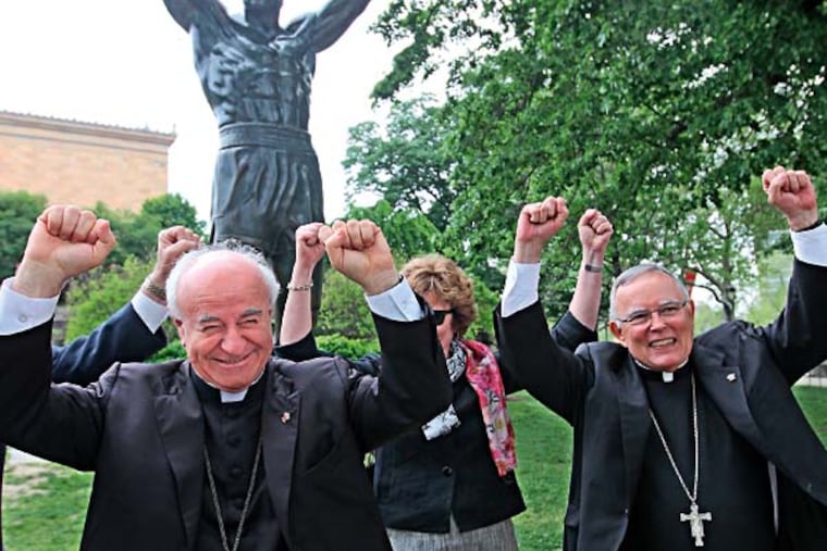 Archbishop Vincenzio Paglia, left, from the Vatican, strikes a very Philadelphia pose in front of the Rocky statue along with Archbishop Charles Chaput, right, and First Lady of Pennsylvania, Susan Corbett, background, on Tuesday during the tour of the city. ( AP PHOTO / The Philadelphia Inquirer / Michael Bryant )