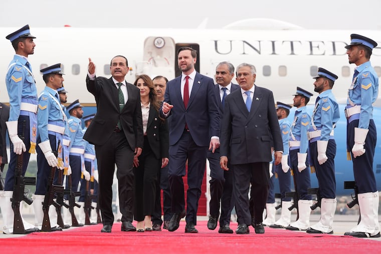 Vice President JD Vance (center) walks with Pakistan's military chief Asim Munir (left) and Foreign Minister Mohammad Ishaq Dar on Saturday after arriving in Islamabad.