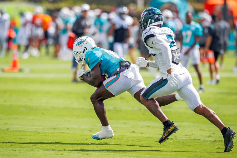Dolphins wide receiver Tyreek Hill runs with the ball against Eagles cornerback Darius Slay during a joint practice on Wednesday in Miami Gardens, Fla.