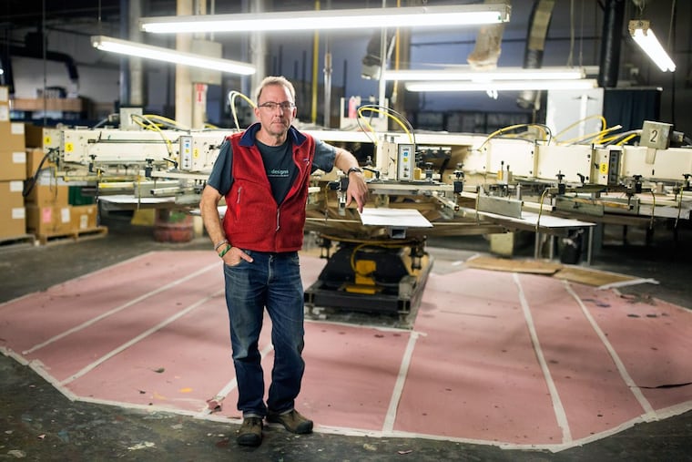 Eric Henry, owner of TS Designs, stands in the facility where he prints T-shirts in Burlington, N.C. He said he’s felt little effect from the state tax cuts Republicans enacted there beginning in 2013.