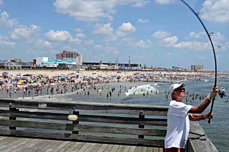 An Ocean City Fishing Club member since 1984, Dave Hinzman of Wilmington, Del. casts his line from the end of the club's pier July 15, 2013. The oldest continuously operating fishing club in America is celebrating its 100th birthday this summer. ( TOM GRALISH / Staff Photographer )