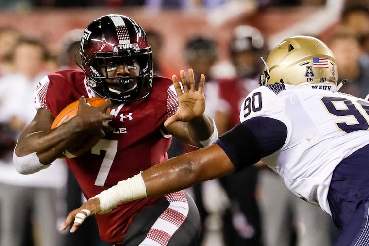 Temple running back Ryquell Armstead holds the football watching Navy defensive end Jarvis Polu. YONG KIM/Staff Photographer