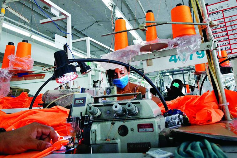 American Apparel employees work at the company's plant in Los Angeles. Without a loan, the company could shut down in two weeks.
