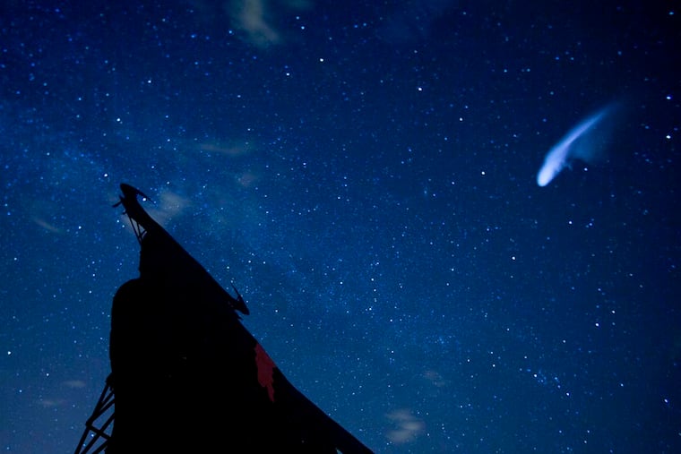 In this long exposure photo, a streak appears in the sky during the annual Perseid meteor shower above a roadside silhouette of a Spanish fighting bull in Spain in 2013.