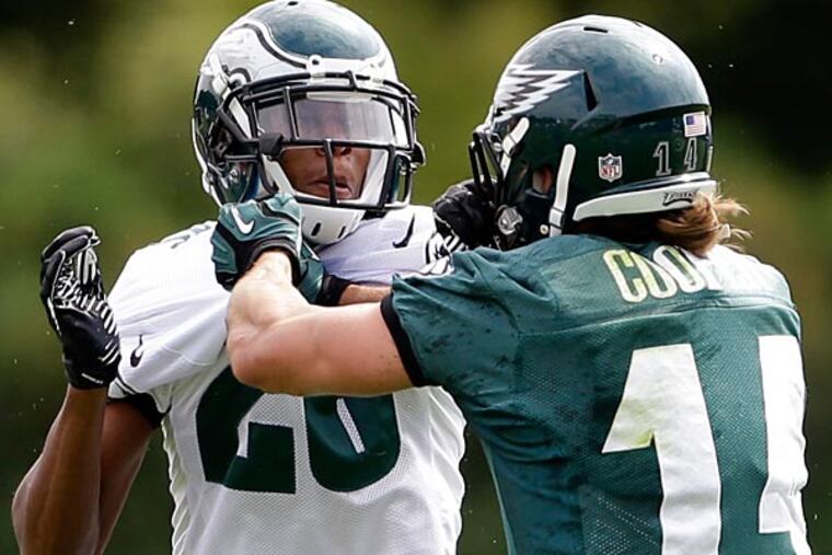 Eagles cornerback Cary Williams and Riley Cooper push each other during practice. (Matt Rourke/AP)