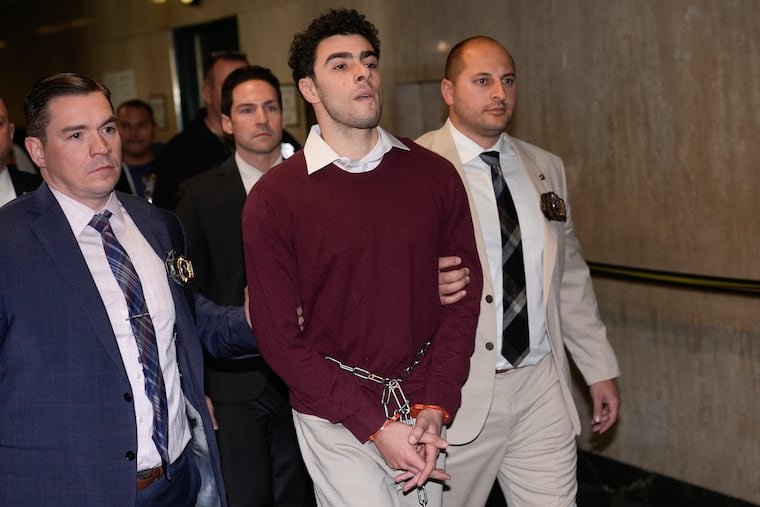 Luigi Mangione is escorted into Manhattan Criminal court on Monday.