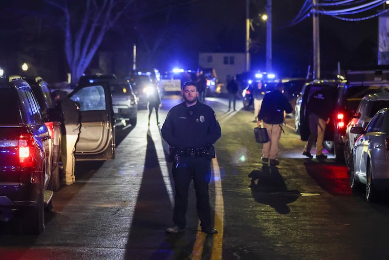 Law enforcement officers are seen outside a storage facility where a suspect in the shooting at Brown University was found dead on Thursday, Dec. 18, in Salem, N.H.