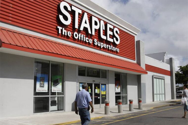 This March 2013 file photo shows a Staples office supply store in Miami. The opening of Postal Service retail centers in dozens of Staples stores around the country is being met with threats of protests and boycotts by the agency's unions. The new outlets are staffed by Staples employees, not postal workers, and labor officials say that move replaces good-paying union jobs with low-wage, nonunion workers. (AP Photo/ Lynne Sladky, File)