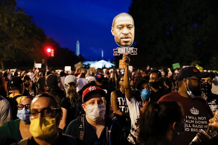 Demonstrators protest Saturday, June 6, 2020, near the White House in Washington, over the death of George Floyd, a black man who was in police custody in Minneapolis. Floyd died after being restrained by Minneapolis police officers.