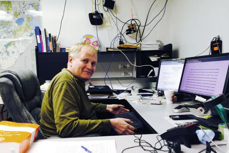John Paff in his basement office, where he files hundreds of document requests a year. (Jan Hefler/Inquirer Staff)