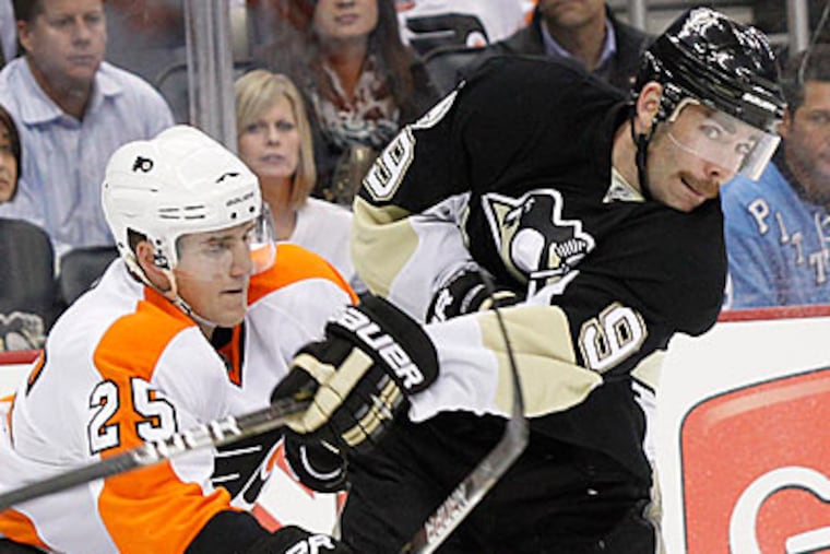 Pittsburgh Penguins' Pascal Dupuis gets tangles up with Philadelphia Flyers' Matt Carle (25) in the second period. (AP Photo/Keith Srakocic)