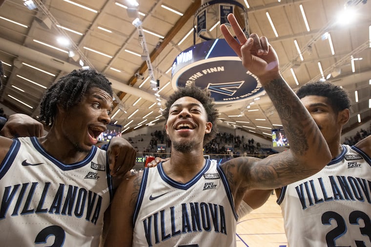 Brandon Slater, left, and Jermaine Samuels, right gather beside Justin Moore of Villanova after their victory over Xavier on Dec. 21, 2021 at the Finneran Pavilion at Villanova University.