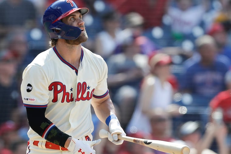 Phillies Bryce Harper watches his two run home run against the Colorado Rockies on Sunday, May 19, 2019 in Philadelphia.