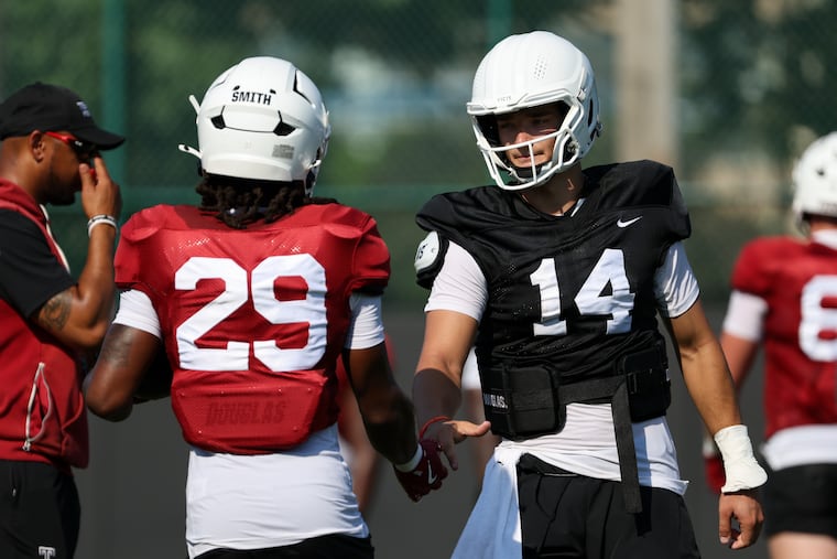 Temple quarterback Jaxon Smolik (14) and running back Hunter Smith (29) during football practice at Edberg-Olson Hall on Saturday.