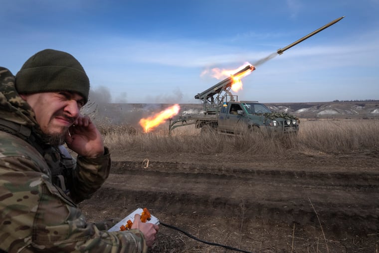 A Ukrainian officer from the 56th Separate Motorized Infantry Mariupol Brigade fires a multiple launch rocket system based on a pickup truck towards Russian positions at the front line, near Bakhmut, Donetsk region, Ukraine, in March. The outgunned and outnumbered Ukrainian troops are increasingly struggling to halt Russian advances as a new U.S. aid package has remained stuck in Congress.
