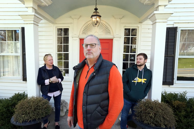 From left, Liz and Ken Frydman and their son Beau stand in front of their country home in Sharon, Conn.