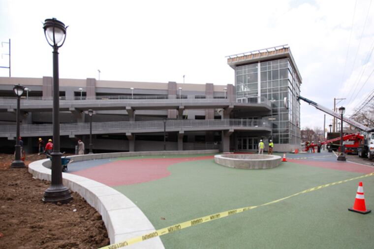 Workers put the final touches on a new, four-story parking garage at the Philadelphia Zoo. (David Swanson / Staff Photographer)