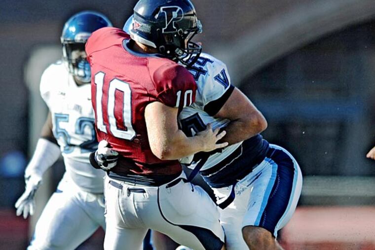 Penn quarterback Alek Torgersen fumbles the football as he is sacked by Villanova linebacker Don Cherry. (Clem Murray/Staff Photographer)