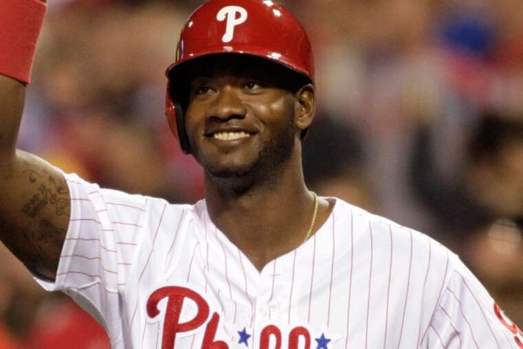 Domonic Brown celebrates after Ryan Howard hit a solo home run against the Miami Marlins in the fourth inning of a baseball game on Thursday, May 2, 2013, in Philadelphia. (H. Rumph Jr/AP)