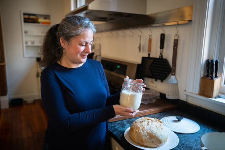 Elizabeth Planet with Joey McSourdoughy, her sourdough starter that helped her get through the pandemic, and a loaf of fresh sourdough bread.