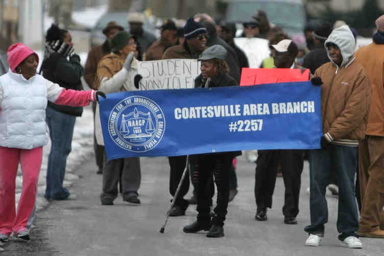 Several dozen marchers assemble for the symbolic walk through Coatesville.