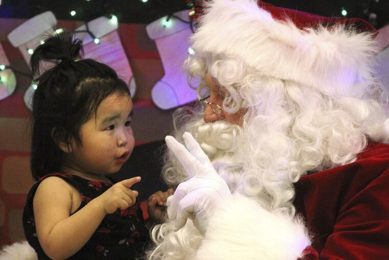 The traditional but flawed look of St. Nicholas: In this one, Caasi Lockwood sits on Santa’s lap in St. Michael, Alaska.