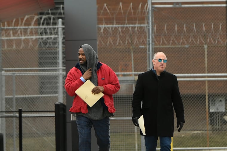 Singer R. Kelly left, walks with his attorney Steve Greenberg right, after being released from Cook County Jail, March 9, 2019, in Chicago. Kelly was freed three days after a judge ordered him jailed until he paid the total amount of back child support that he owed. Kelly was freed Saturday, three days after a judge ordered him jailed until he paid the total amount of back child support that he owed. (AP Photo/Paul Beaty)