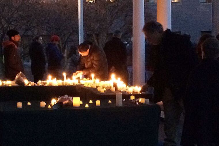 Mourners light candles last night during a vigil for Cayman Naib, found dead after a four-day search. MARI SCHAEFER / STAFF