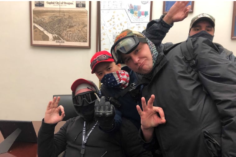 From left to right: Brian Healion, Freedom Vy, Zach Rehl, and Isaiah Giddings pose for a photo on Jan. 6 in the office of Sen. Jeff Merkley (D., Ore.), according to federal prosecutors.