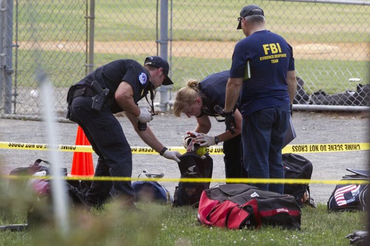 An FBI team inspects the contents of one of the many bags left at the shooting scene. Capitol officers were praised as heroes. “Without them,” one lawmaker said, “it would have been a bloodbath.”