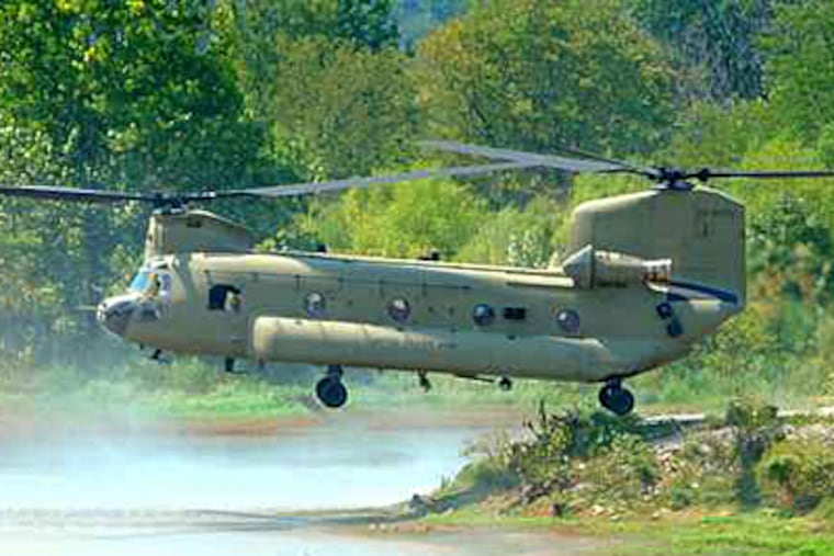 Pilot demonstrating digital flight controls of a Chinook, a big heavy-lift helicopter, designed and built locally. (Inquirer file photo)