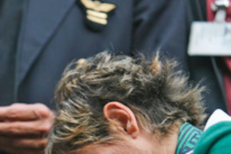 An Alitalia worker at the airport in Rome reacted yesterday to news of the failed deal with investors.