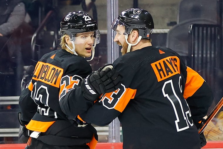 Flyers left wing Oskar Lindblom celebrates his first period goal with teammate center Kevin Hayes against the Chicago Blackhawks on Saturday, March 5, 2022 in Philadelphia.