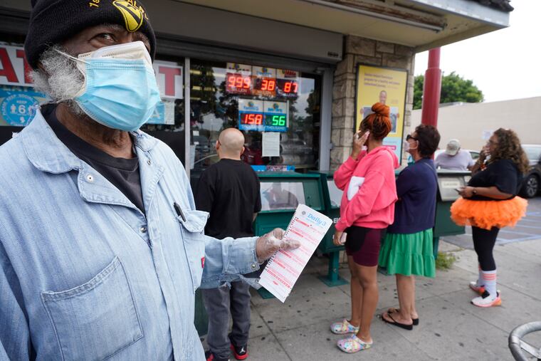 Philip Smith waits in line to purchase Powerball tickets at the Blue Bird Liquor store in Hawthorne, Calif., on Monday.