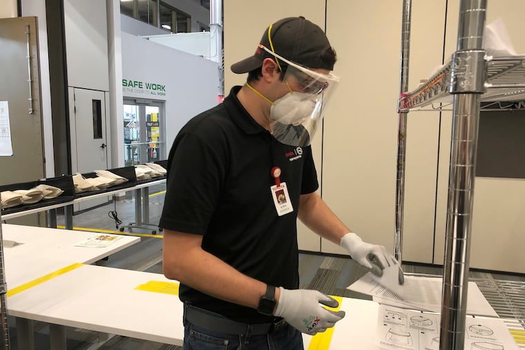 This photo provided by Toyota shows Toyota employee Kirk Barber making face shields at the Toyota factory in Georgetown, Ky.