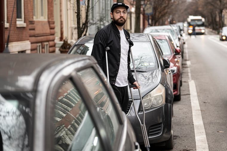 Robert Clendaniel, near his car parked along Spruce Street in Philadelphia, is among the plaintiffs in a potential class-action lawsuit filed against the city for its so-called courtesy tow problem.