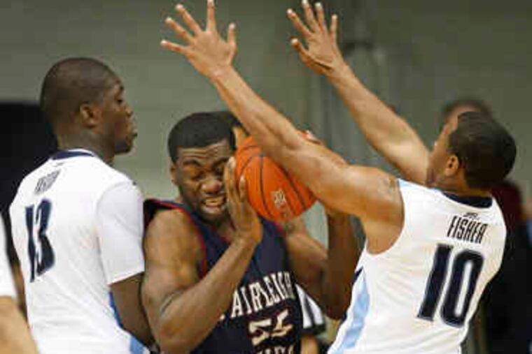 Villanova freshman center Mouphtaou Yarou (left) and Corey Fisher box in Fairleigh Dickinson's Alvin Mofunanya. Yarou was the center of controversy earlier this week when his age was called into question.