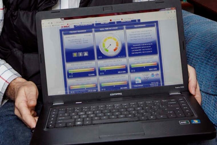 David Director holds a laptop that shows his home electricity usage created from data transmitted to his computer from The Energy Detective. ( MICHAEL S. WIRTZ / STAFF PHOTOGRAPHER ).
