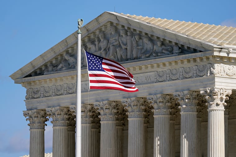 FILE - An American flag waves in front of the Supreme Court building on Capitol Hill in Washington, on Nov. 2, 2020. (AP Photo/Patrick Semansky, File)