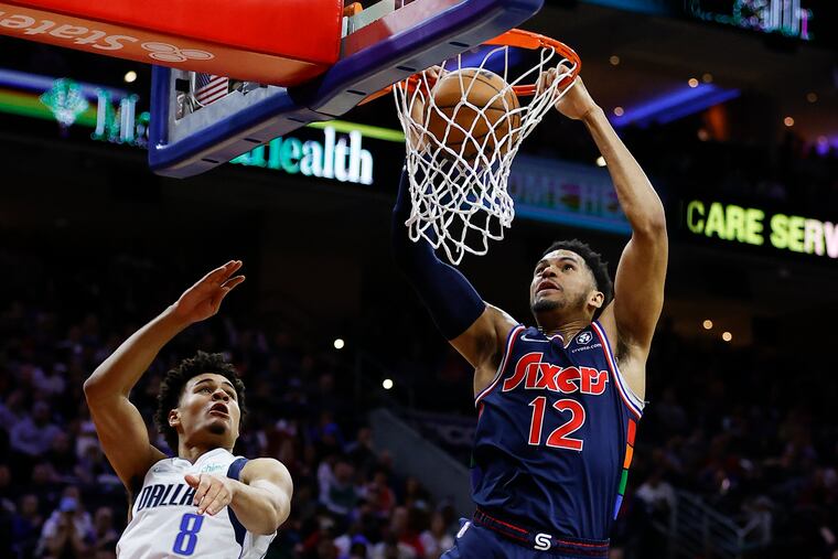 Sixers forward Tobias Harris dunks the basketball past Dallas Mavericks guard Josh Green in the second quarter on Friday, March 18, 2022 in Philadelphia.