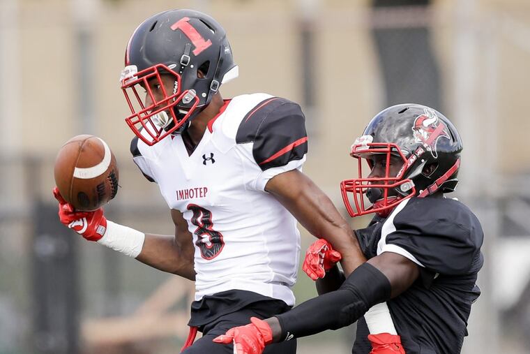 Imhotep’s Yusuf Terry (left) holds off Northeast High defender Alex Martin during the teams’ game on Sept. 8. Terry scored a touchdown on the play.